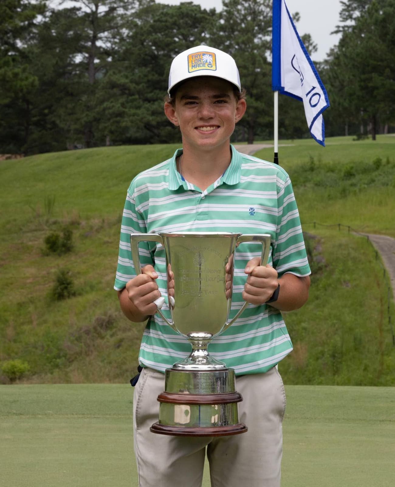 Young golfer holding a trophy