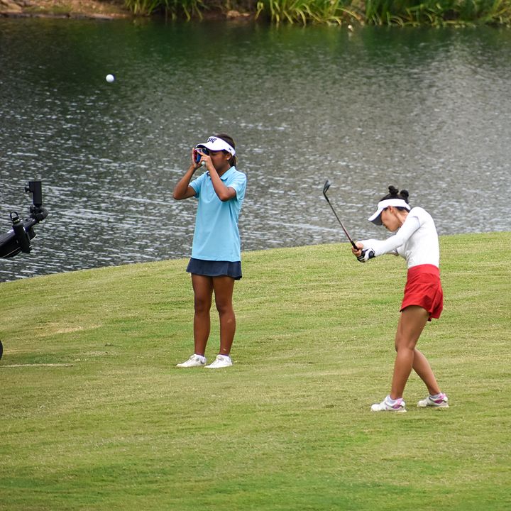 junior golfer making a shot