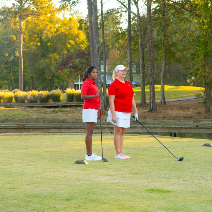 two female golfers at the tee box
