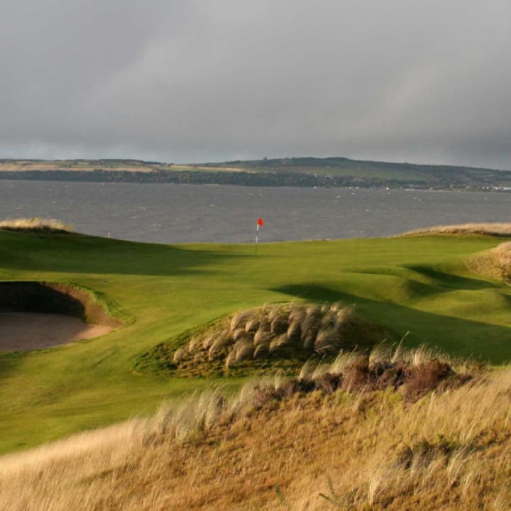 Castle Stuart Golf Links course at sunset.